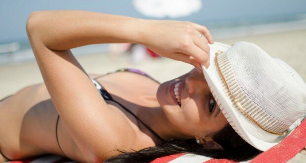 women with hat on the beach